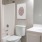 a bathroom with a toilet sink and a mirror